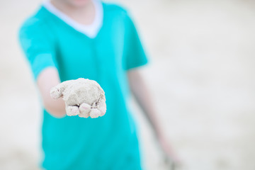 Child holding sand