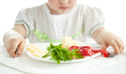 Obraz na płótnie Canvas Little girl eating her dinner