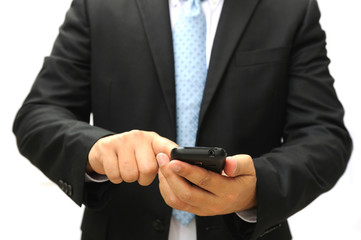 Business man holding and touching a smart phone.