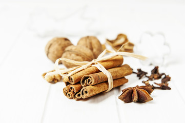 christmas still life with spice and nuts on white wooden table