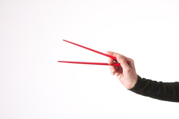 woman hand with red chopsticks