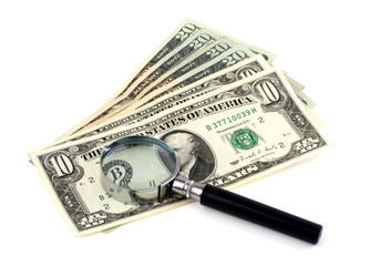 dollars with a magnifying glass on a white background