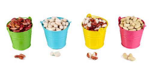 Different types of beans in colored buckets isolated on white