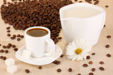 A cup of strong coffee and sweet cream on wooden table close-up