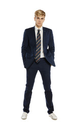 Handsome man in suit standing with hands in pockets