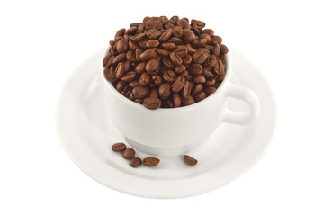 White cup and saucer full of coffee beans