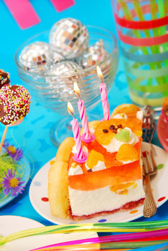 cake with three candles on birthday party table for child
