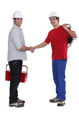 craftsman and apprentice shaking hands
