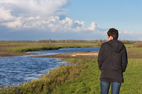 Woman in a beautiful wetland landscape in the Netherlands