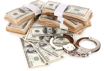 Handcuffs and packs of dollars isolated on white