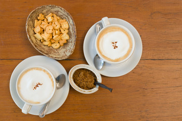 Top view White ceramic cup of coffee and letter Biscuits