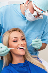 Dentist examines teeth of the patient on the dentist's chair