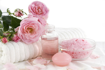 Spa setting with branch roses on towel ,salt in bowl,