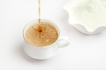 Cup of tea with dairy milk powder