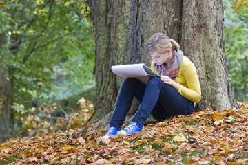 Lovely girl drawing in the park