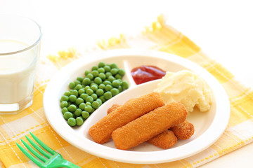 Fish fingers, mushed potato and green-peas on plate