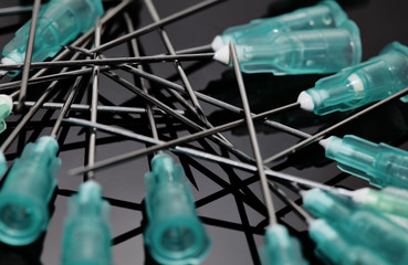 many medical needles. Stylish background.