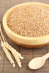 Wooden bowl full of wheat bran