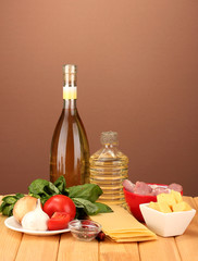 Lasagna ingredients on brown background