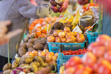 Bunch of different onions, carrots, tomatoes and potatoes on cit