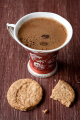Cup of coffee and cookies on a vintage board