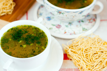 Noodles in chicken broth with herbs