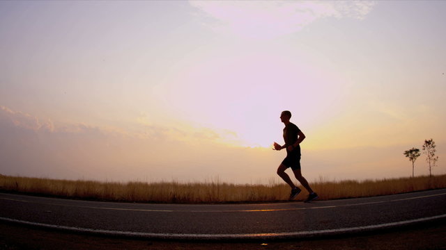 Morning silhouette healthy runner on track