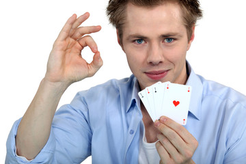 Young man holding playing cards