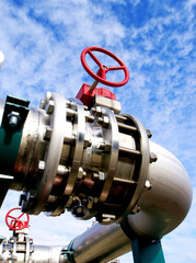 Industrial zone, Steel pipelines and valves against blue sky