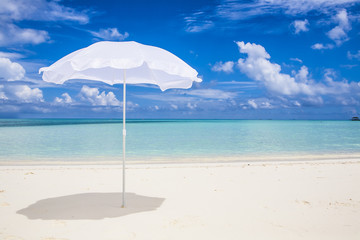 white sunshade  at the beach