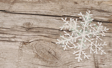 Christmas decorations (snowflake) on wooden background