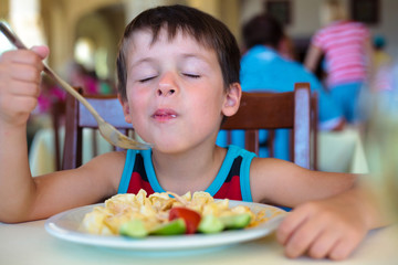 Cute little boy enjoying food
