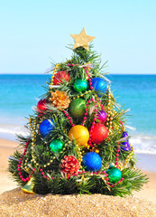 Christmas tree on the sand in the beach