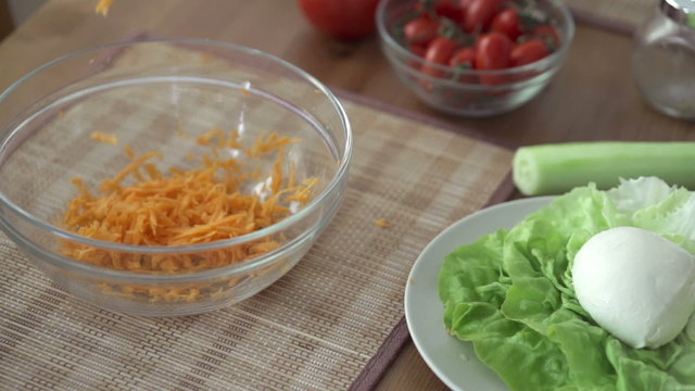 Chopped carrot falling into bowl, slow motion shot at 240fps
