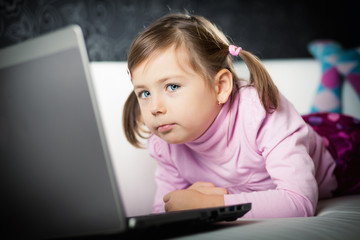 Cute girl looking at laptop