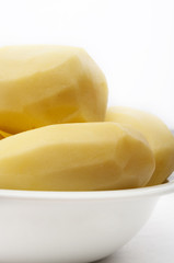 Raw peeled potatoes isolated on a white background