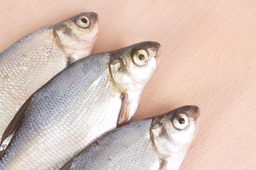 Fish fry on a wooden board. Isolated on white