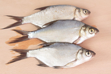 Fish fry on a wooden board. Isolated on white