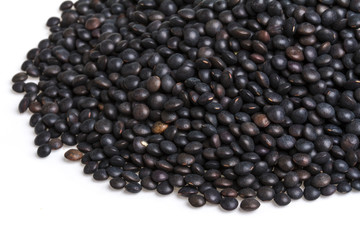 Heap of black lentil isolated on white