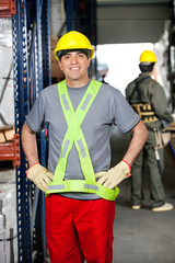 Mid Adult Foreman With Hands On Hips At Warehouse