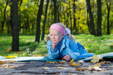 Mischievous small girl in a park