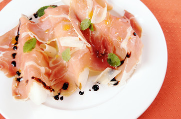 Prosciutto with melon on a plate