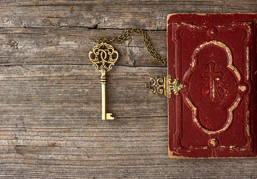 key and old bible book cover