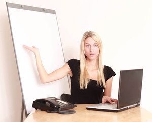 Frau im Büro mit Flipchart präsentiert etwas