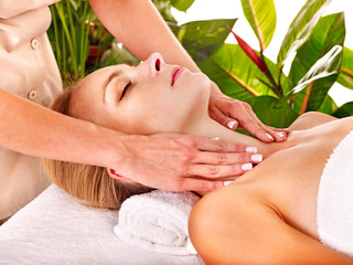 Woman getting  facial massage .