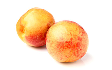 Two ripe peaches isolated on white background