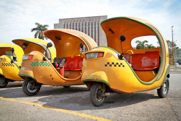 Yellow coco taxi in  Havana