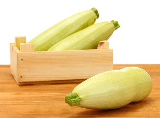 squash in a box on wooden table on white background close-up