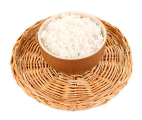 Bowl of rice on wicker mat isoalted on white