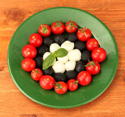 cheese mozzarella with vegetables in the plate